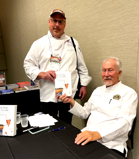 Stephen Walk, of Kent State University, is an oil saving customers with Frylow. He is greeted by Ferdinand Metz, a Frylow Certifier.