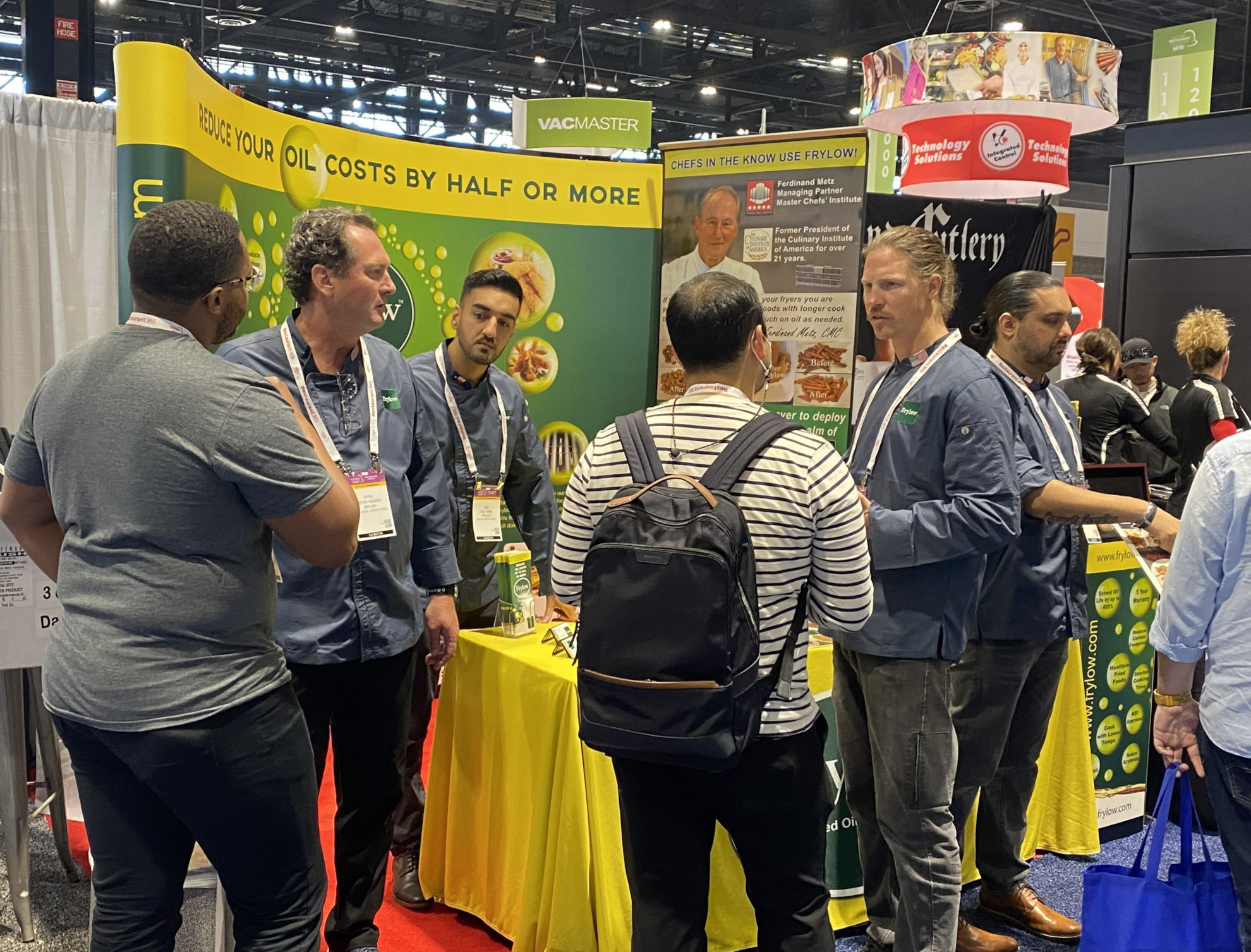 The Frylow America Team Answer Questions about cutting oil costs at a Tradeshow